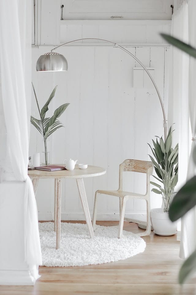 white room walls White room with lightwood table and chair